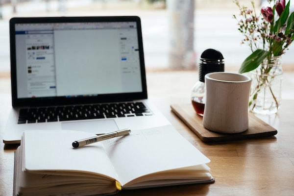 how to write blog posts quickly, laptop and notebook