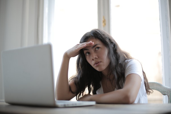 woman in front of laptop tired of blogging